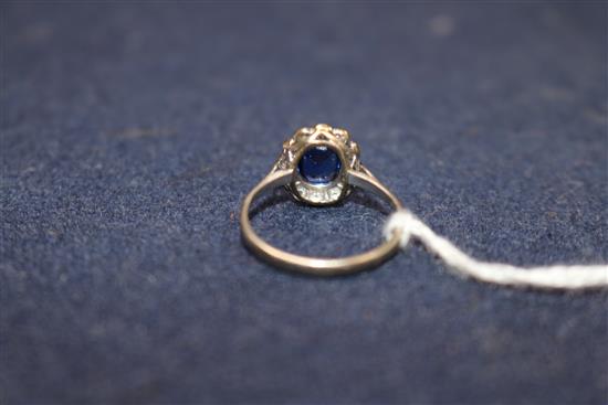 A mid 20th century white metal, synthetic sapphire? and diamond cluster dress ring, size O/P.